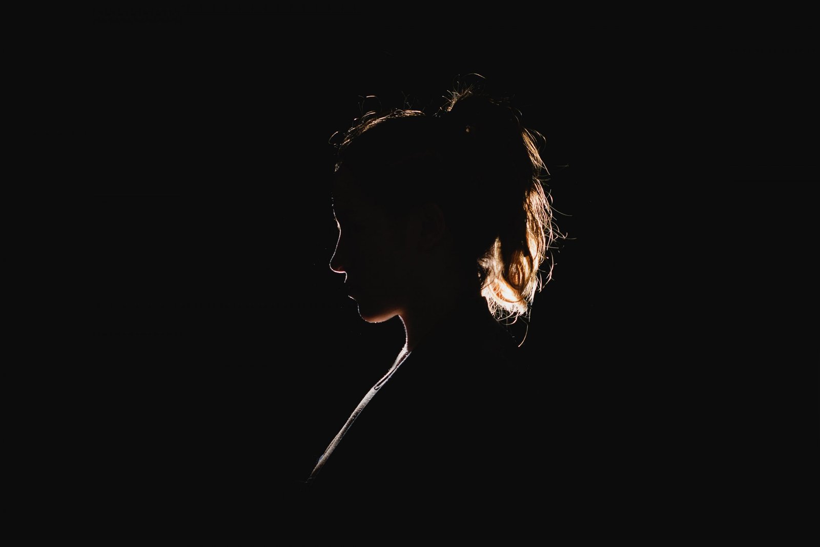 side profile of woman in the dark