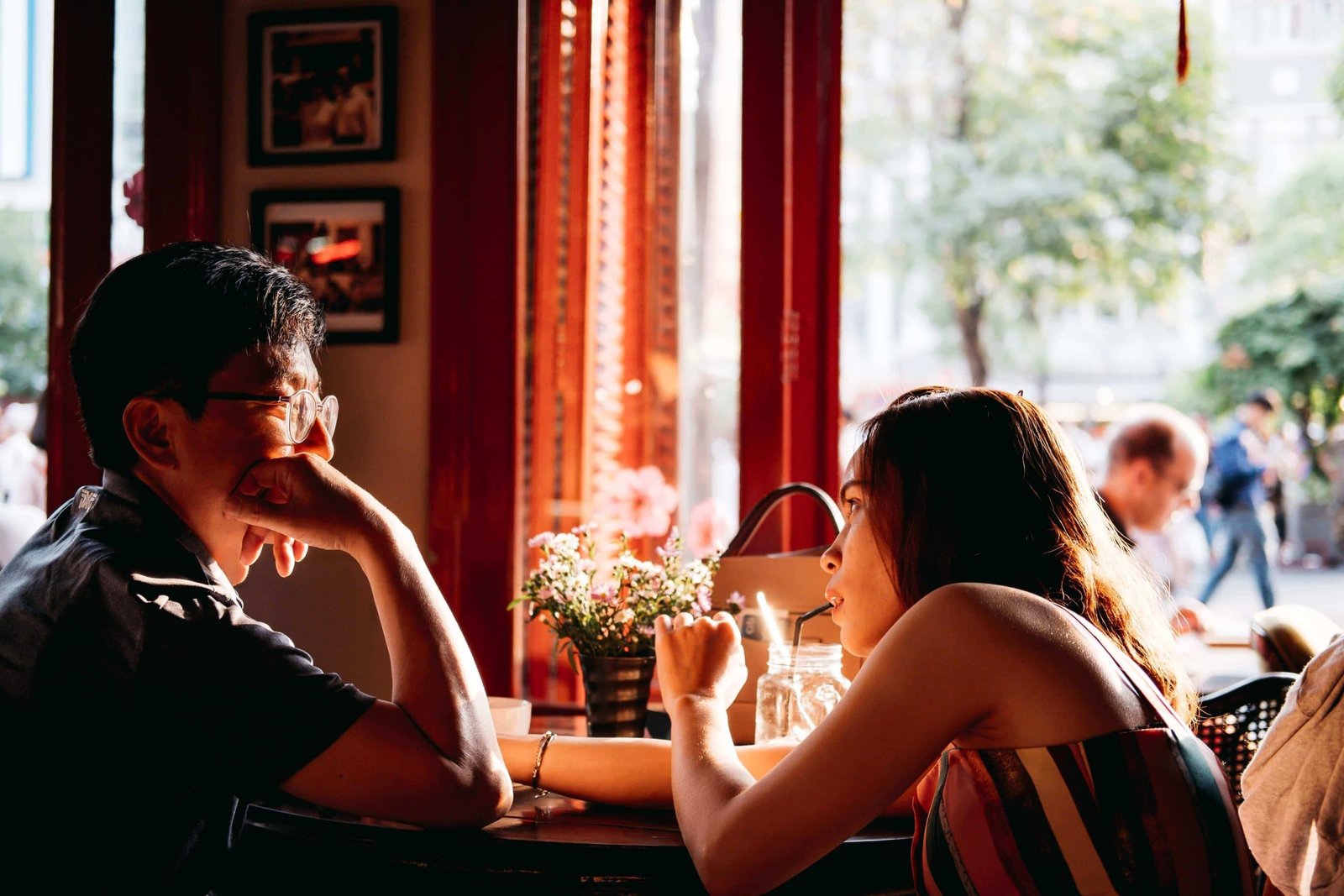 asian man and asian woman sitting at cafe