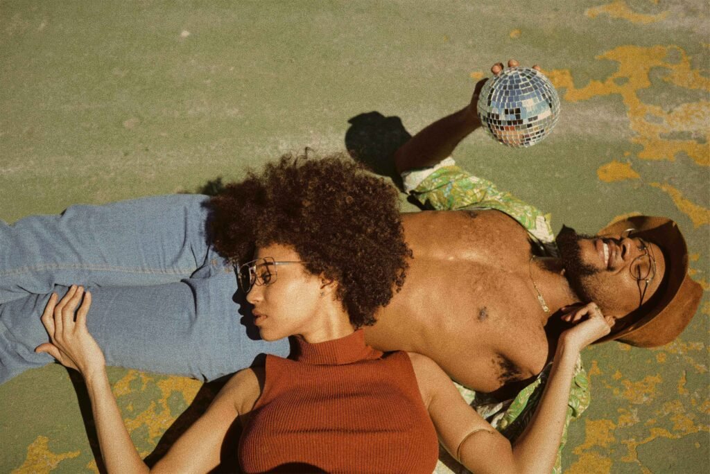 black woman resting on stomach of black man